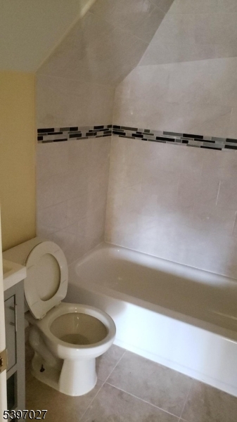 1371 Clinton Avenue Irvington, NJ 07111 - Photo 18 of 41 a bathroom with a toilet and a bathtub