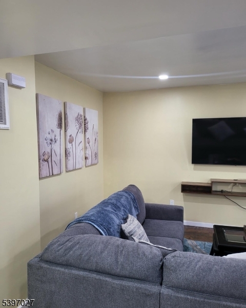 1371 Clinton Avenue Irvington, NJ 07111 - Photo 20 of 41 a living room with furniture and a flat screen tv