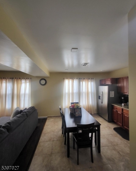 1371 Clinton Avenue Irvington, NJ 07111 - Photo 21 of 41 a living room with furniture a large window and stainless steel appliances