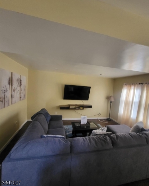 1371 Clinton Avenue Irvington, NJ 07111 - Photo 22 of 41 a living room with furniture and a flat screen tv