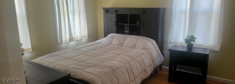 1371 Clinton Avenue Irvington, NJ 07111 - Photo 24 of 41 a bed sitting in a bedroom next to a window