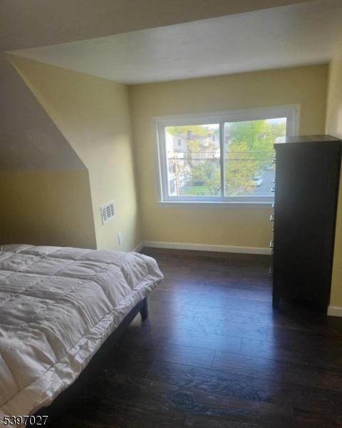 1371 Clinton Avenue Irvington, NJ 07111 - Photo 25 of 41 a bed sitting in a bedroom next to a window