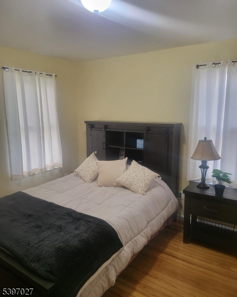 1371 Clinton Avenue Irvington, NJ 07111 - Photo 28 of 41 a bedroom with a bed and a window