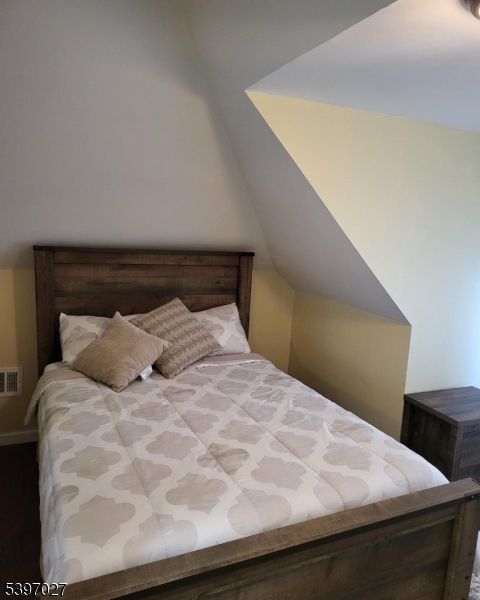 1371 Clinton Avenue Irvington, NJ 07111 - Photo 29 of 41 a bed sitting in a bedroom next to a window