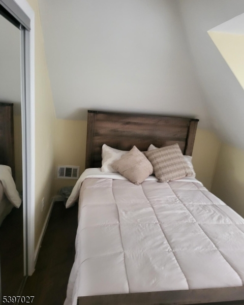 1371 Clinton Avenue Irvington, NJ 07111 - Photo 33 of 41 a bed sitting in a bedroom next to a window