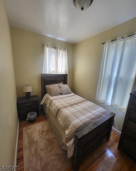 1371 Clinton Avenue Irvington, NJ 07111 - Photo 34 of 41 a bed sitting in a bedroom next to a window