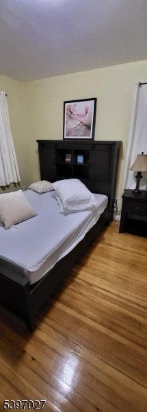 1371 Clinton Avenue Irvington, NJ 07111 - Photo 35 of 41 a bedroom with a bed and a dresser