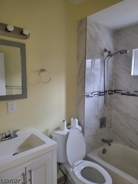 1371 Clinton Avenue Irvington, NJ 07111 - Photo 38 of 41 a bathroom with a sink toilet a mirror and shower