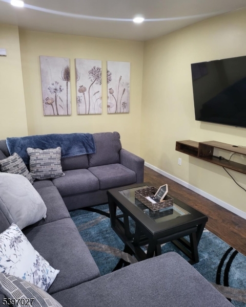 1371 Clinton Avenue Irvington, NJ 07111 - Photo 40 of 41 a living room with furniture and a flat screen tv