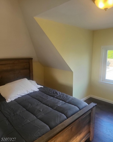 1371 Clinton Avenue Irvington, NJ 07111 - Photo 7 of 41 a bed sitting in a bedroom next to a window