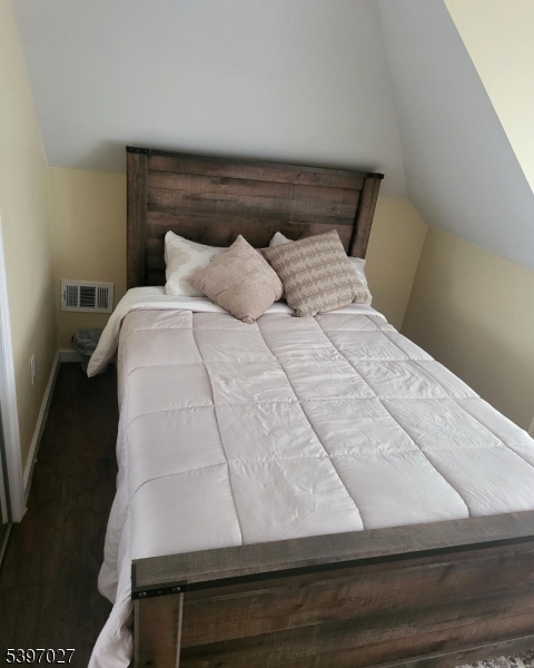 1371 Clinton Avenue Irvington, NJ 07111 - Photo 10 of 41 a bed sitting in a bedroom next to a window