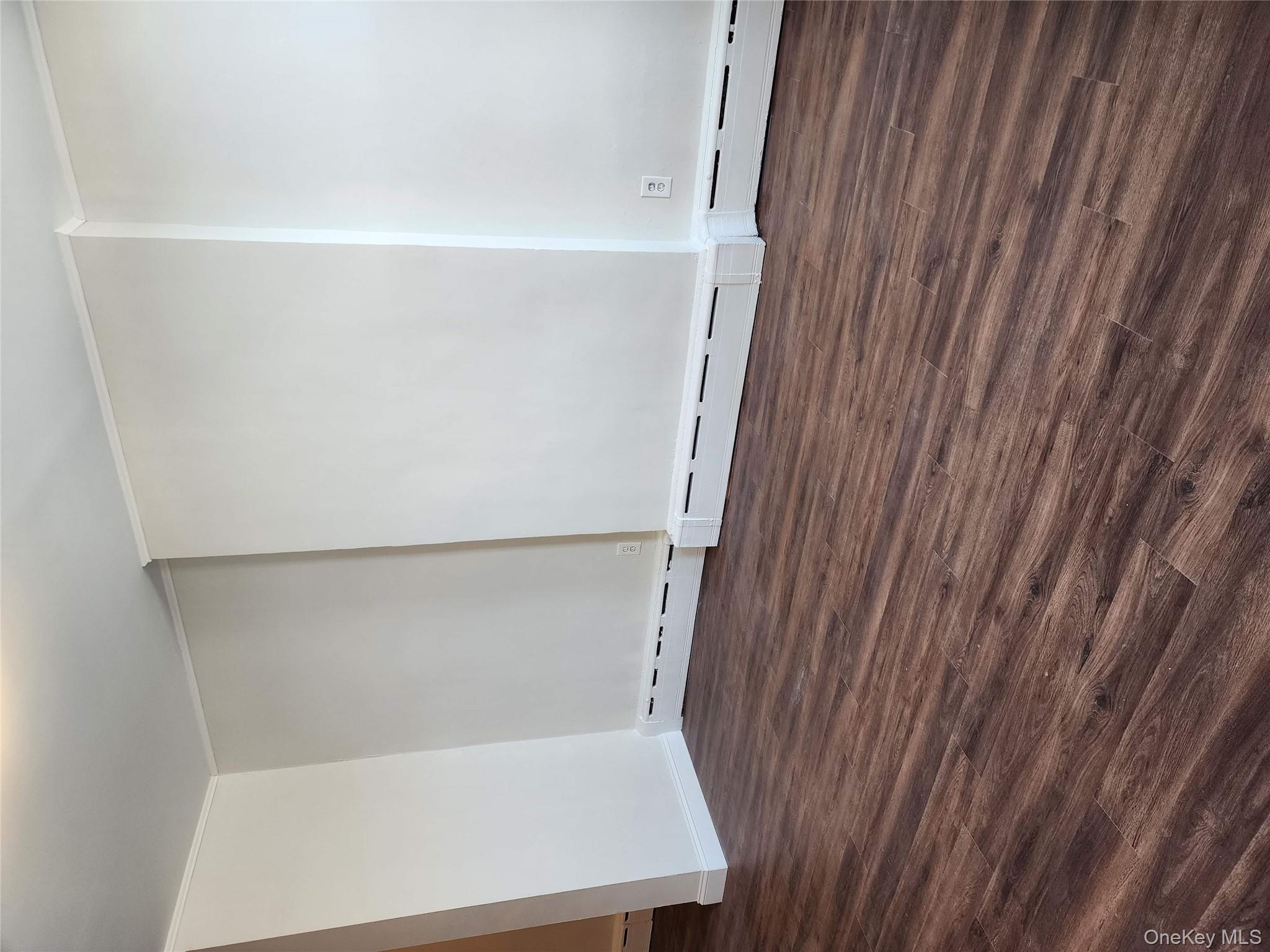 64-10 Myrtle Avenue Queens, NY 11385 - Photo 12 of 15 an empty room with wooden floor