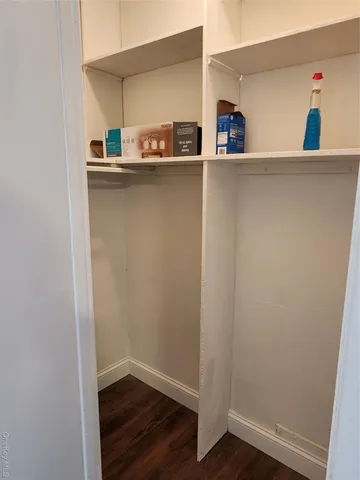 a view of storage and utility room with wooden floor
