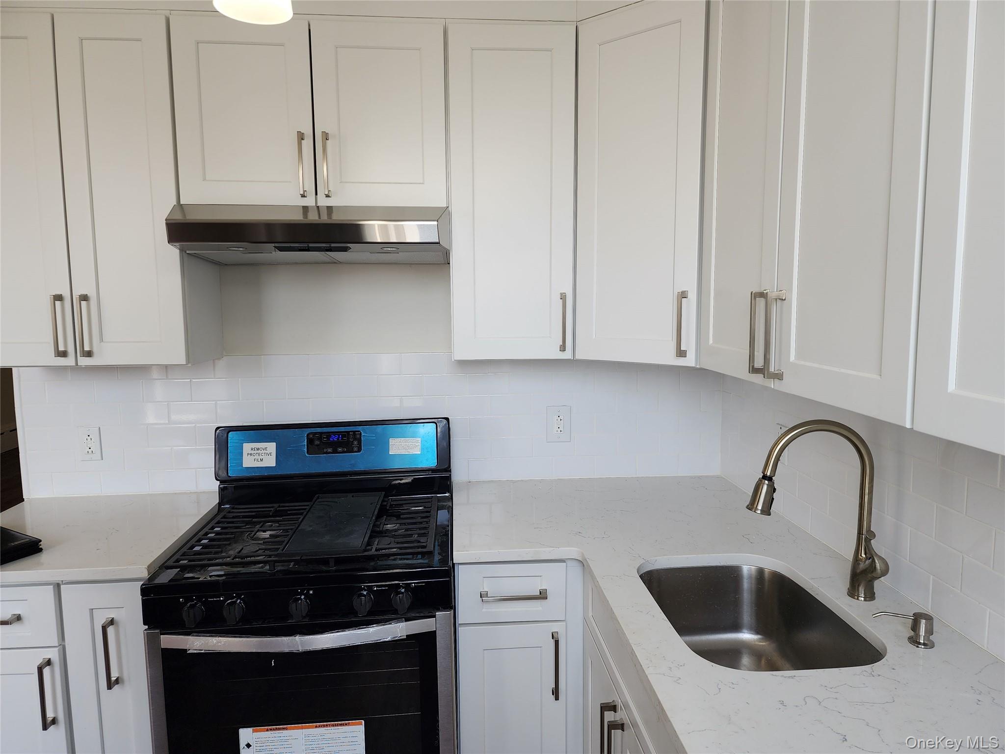64-10 Myrtle Avenue Queens, NY 11385 - Photo 4 of 15 a kitchen with a sink and cabinets