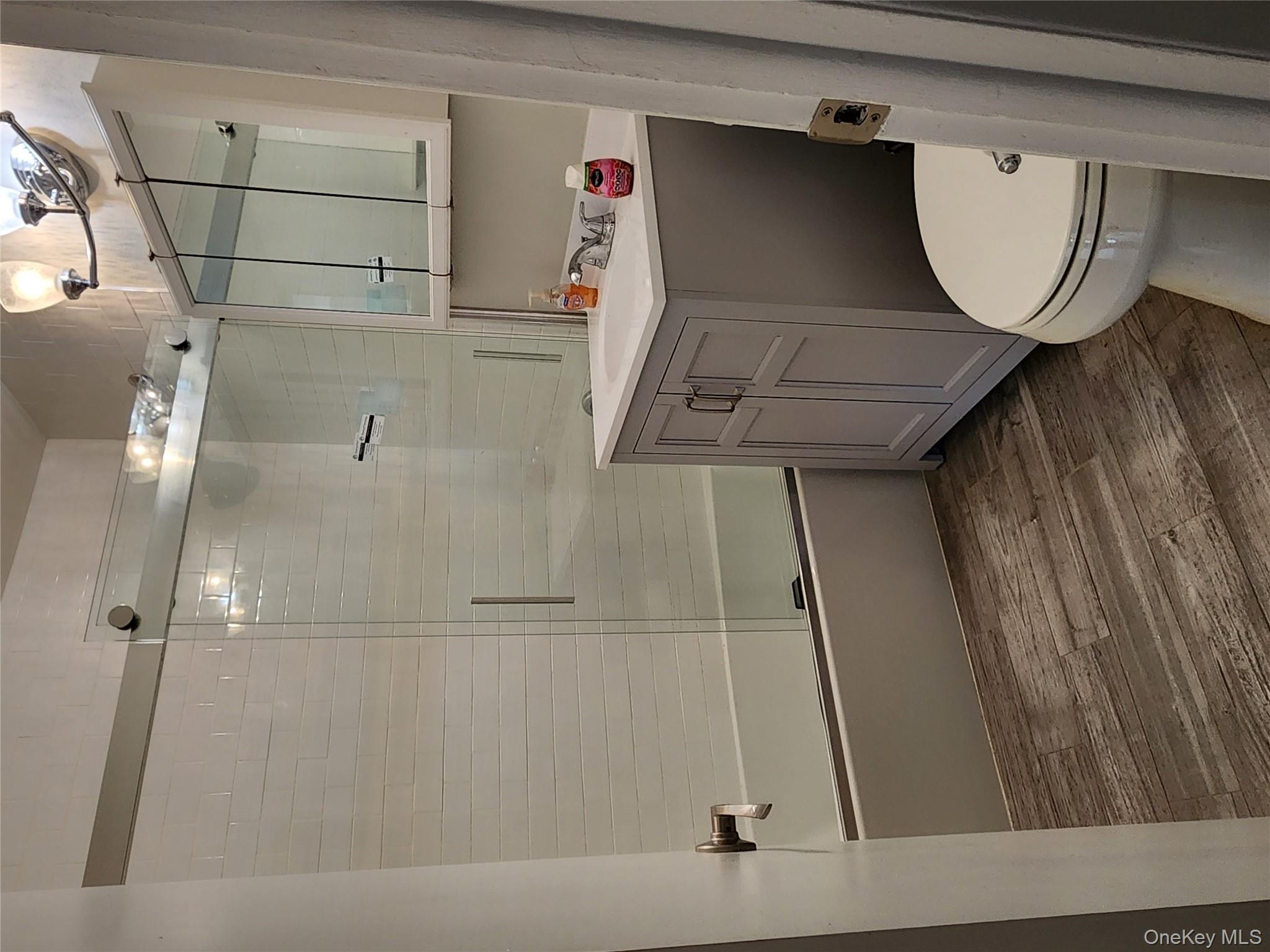 64-10 Myrtle Avenue Queens, NY 11385 - Photo 6 of 15 a bathroom with a sink a toilet and shower