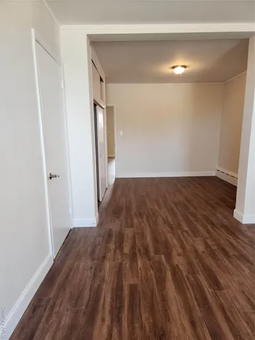 a view of a room with wooden floor and stairs