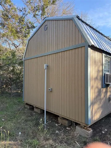 a view of a small house with backyard
