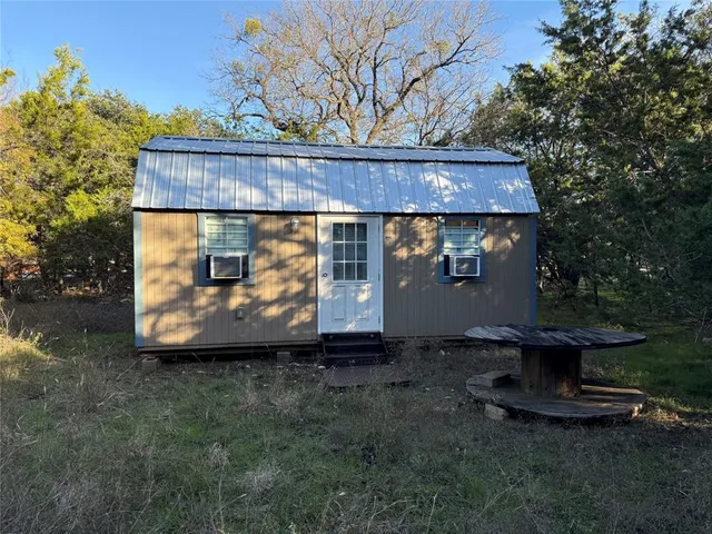 a view of a house with a tree