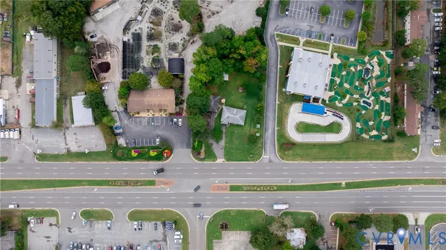 an aerial view of a house with garden space and street view