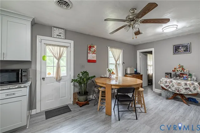 a view of a dining room with furniture window and wooden floor
