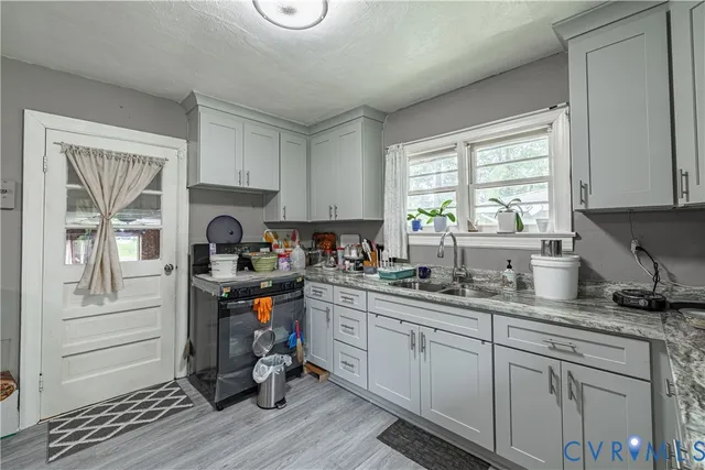 a kitchen with a sink stove and cabinets