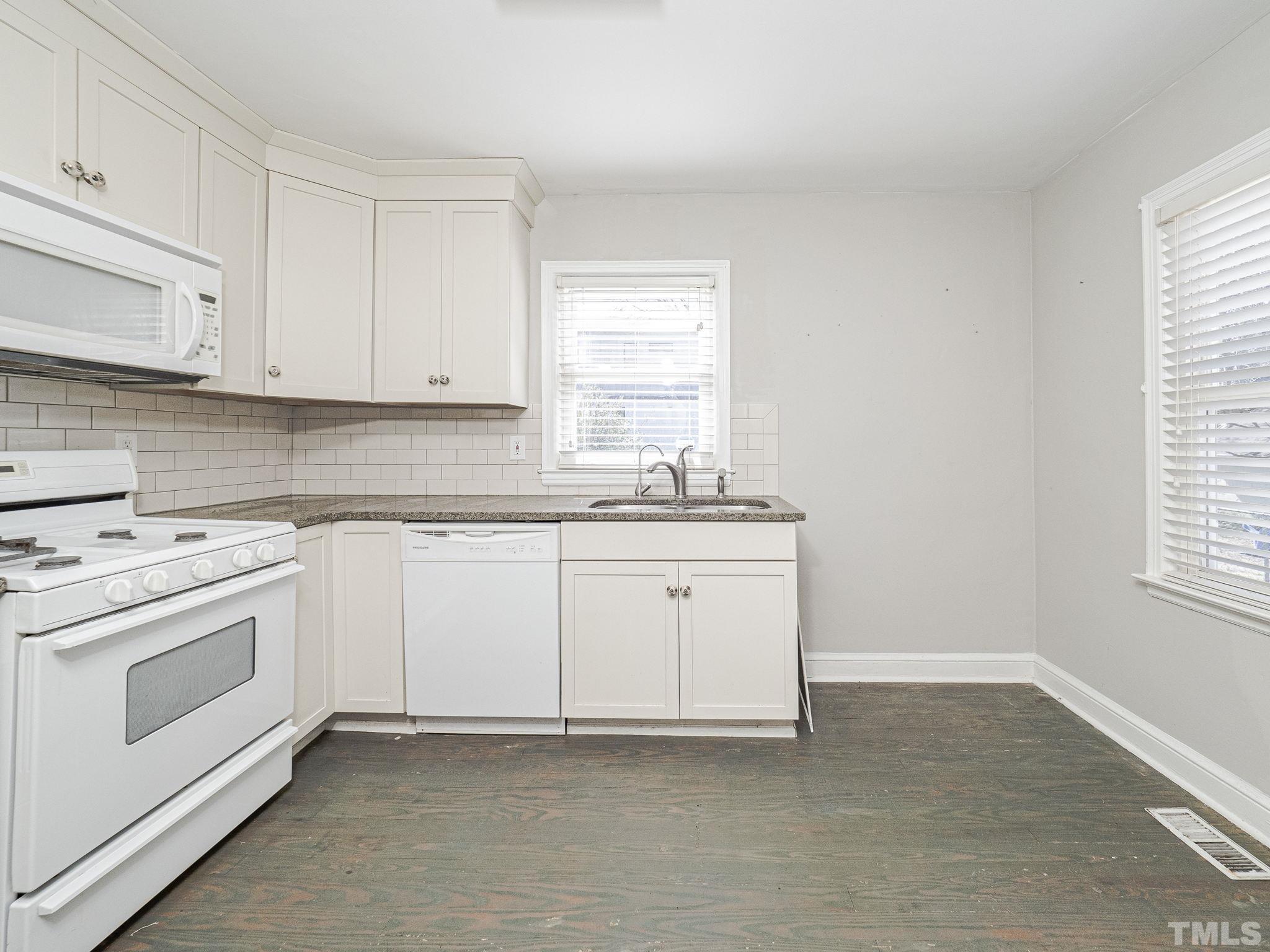 716 Hamilton Road Raleigh, NC 27604 - Photo 11 of 15 a kitchen with granite countertop white cabinets and white appliances