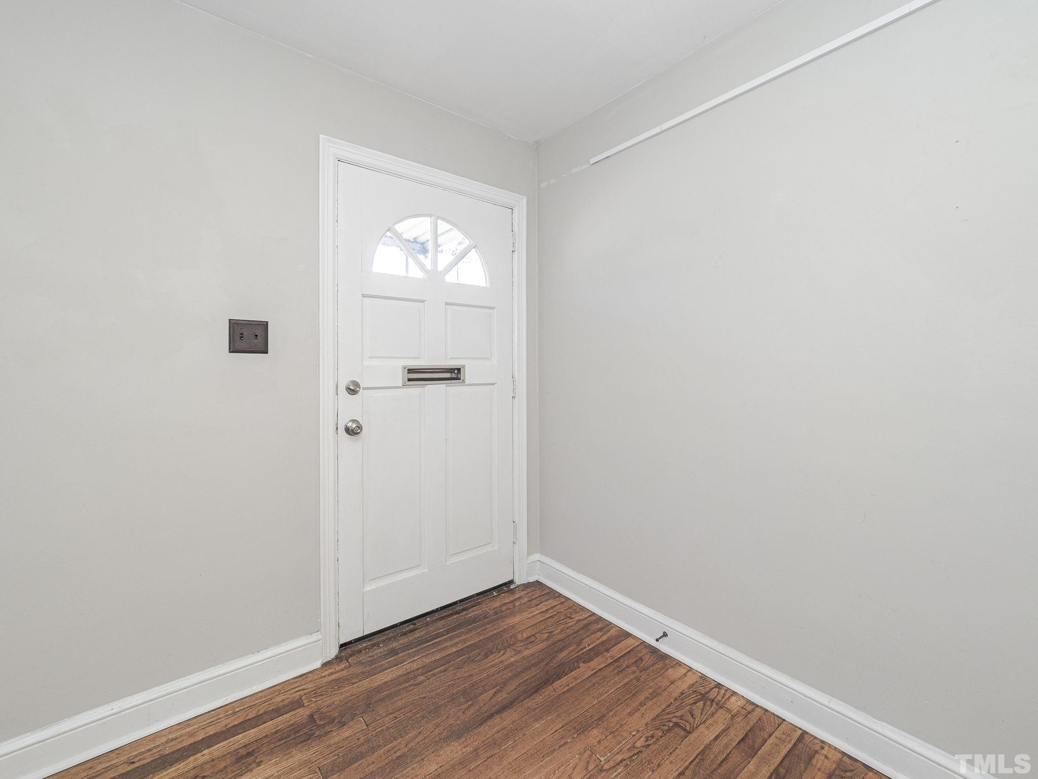 716 Hamilton Road Raleigh, NC 27604 - Photo 3 of 15 an empty room with wooden floor and windows