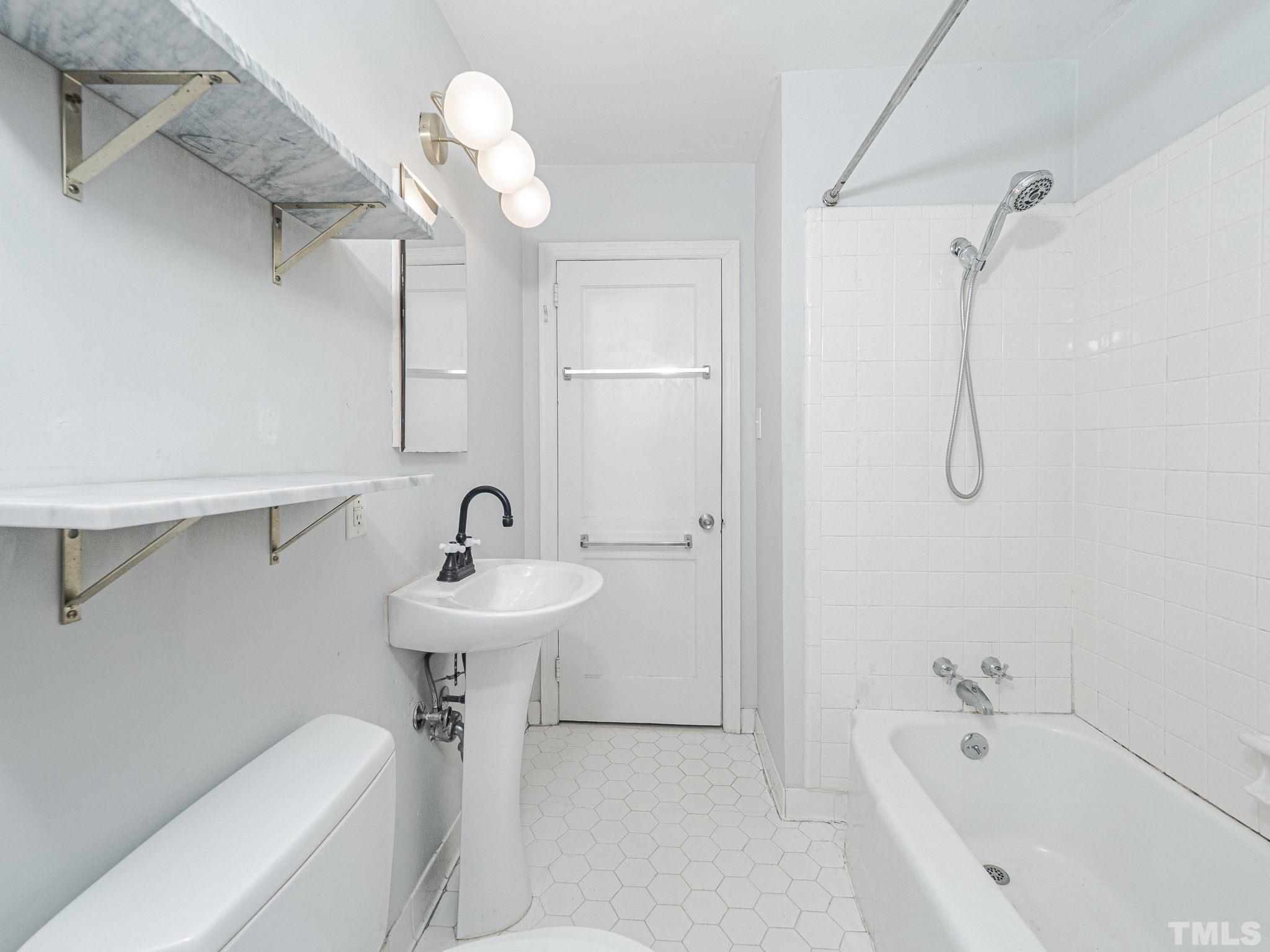 716 Hamilton Road Raleigh, NC 27604 - Photo 7 of 15 a bathroom with a sink a toilet and shower