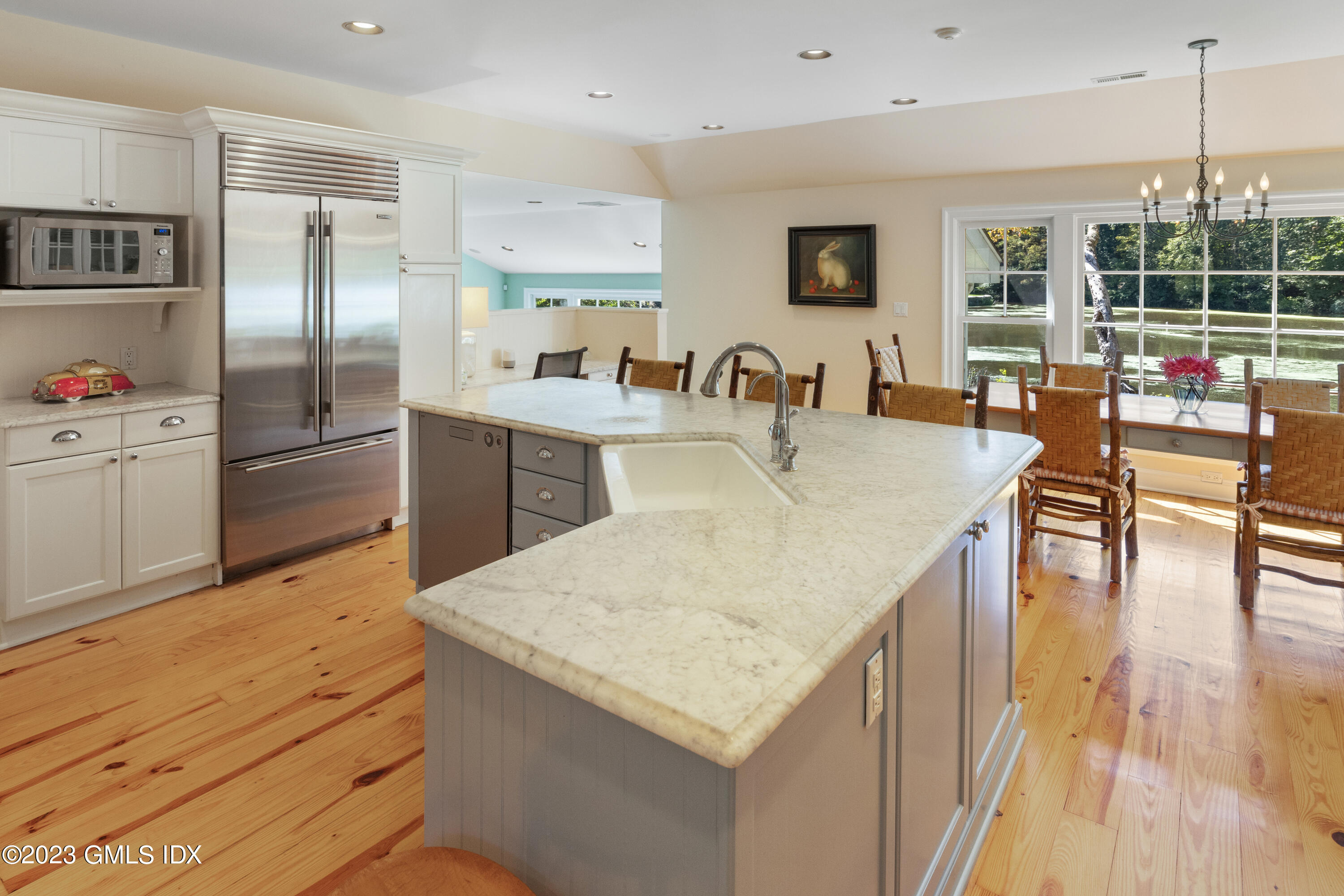 284 Riversville Road Greenwich, CT 06831 - Photo 8 of 34 a kitchen with stainless steel appliances granite countertop a table chairs refrigerator and sink