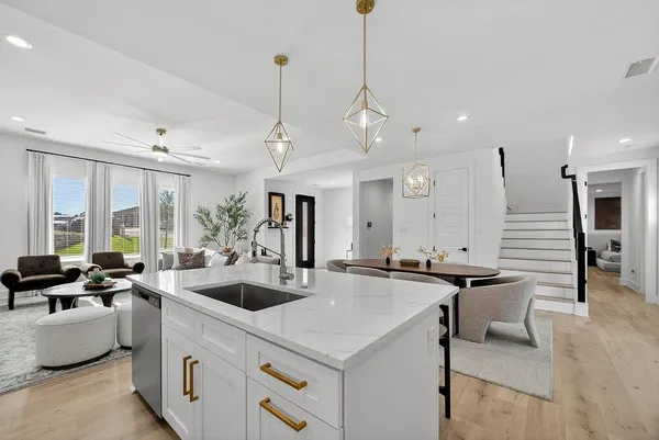 a kitchen with counter top space and living room