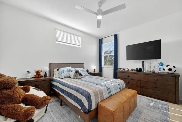 a bedroom with bed and a flat screen tv