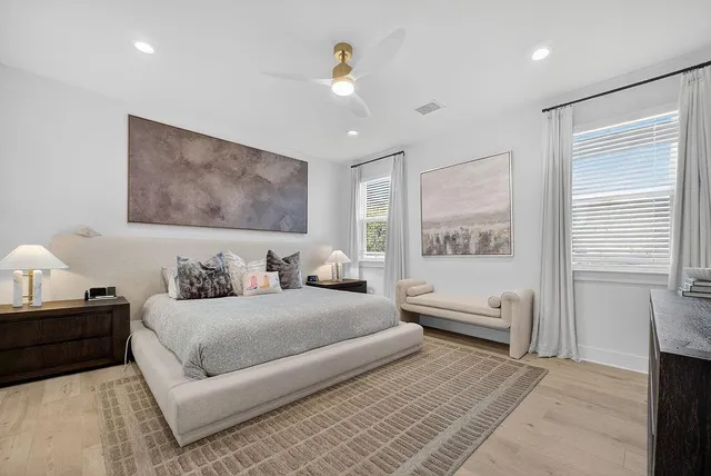 a bedroom with a large bed and a window