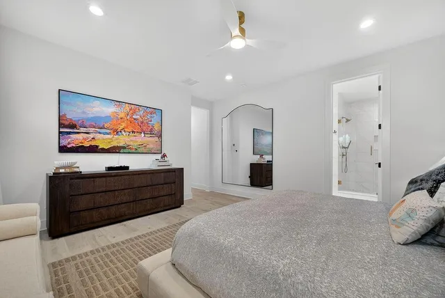 a bed room with furniture and a flat screen tv