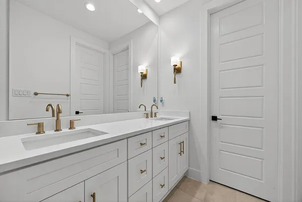 a bathroom with a double vanity sink and a mirror