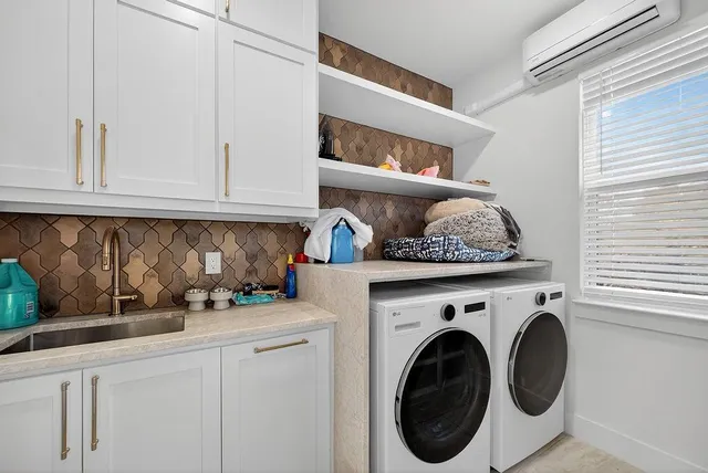 a kitchen with white cabinets and a wooden floor