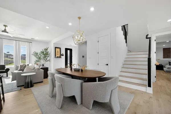 a dining room with furniture and wooden floor