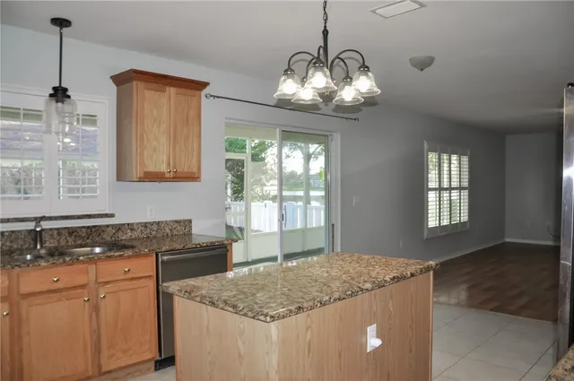 a kitchen with stainless steel appliances granite countertop stove top oven and cabinets