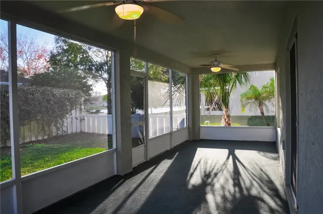 a view of a room with large windows and yard