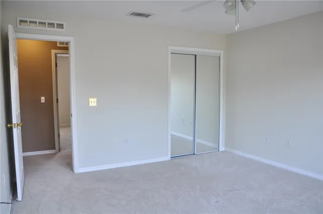an empty room with closet and a window