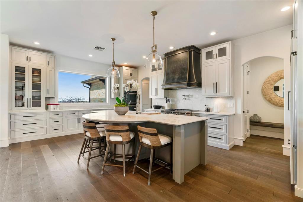 2106 County Road Paris, TX 75462 - Photo 11 of 40 a kitchen with stainless steel appliances kitchen island granite countertop a stove a sink and a wooden floors