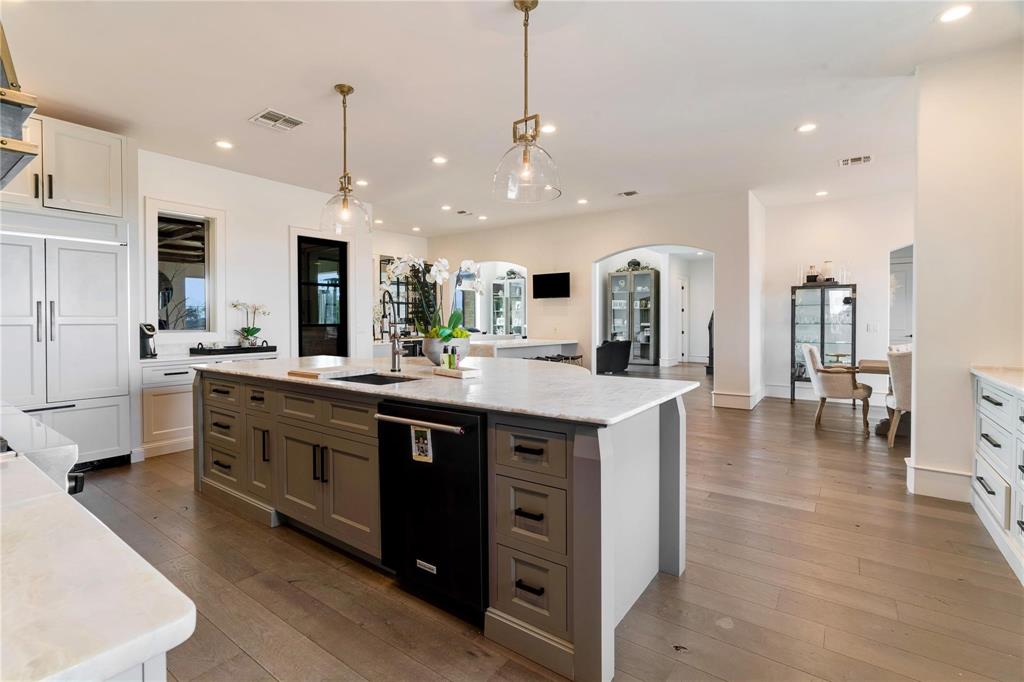 2106 County Road Paris, TX 75462 - Photo 12 of 40 a large kitchen with stainless steel appliances kitchen island granite countertop a large kitchen island a stove a sink a dining table and chairs