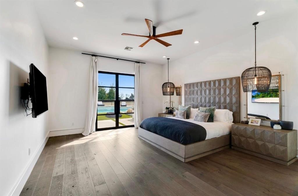 2106 County Road Paris, TX 75462 - Photo 15 of 40 a spacious bedroom with a bed and a flat screen tv