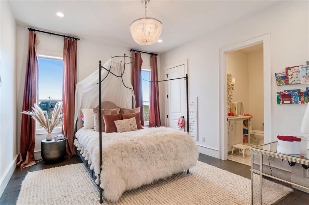 2106 County Road Paris, TX 75462 - Photo 20 of 40 a bedroom with a bed chandelier and a window