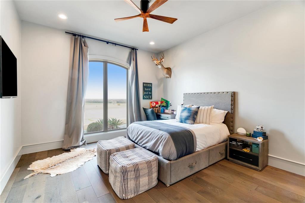 2106 County Road Paris, TX 75462 - Photo 22 of 40 a spacious bedroom with a bed and a couch