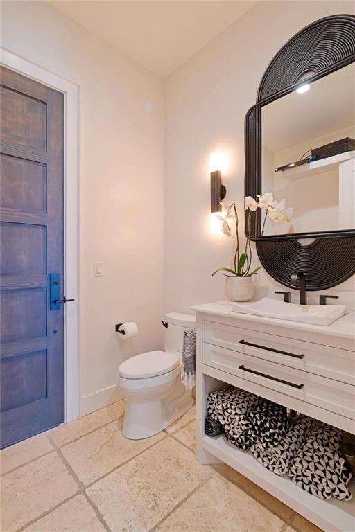 2106 County Road Paris, TX 75462 - Photo 24 of 40 a bathroom with a toilet a sink and mirror
