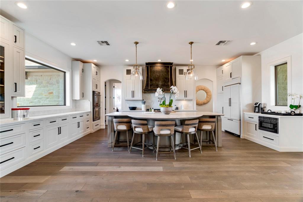 2106 County Road Paris, TX 75462 - Photo 9 of 40 a large kitchen with cabinets table and chairs