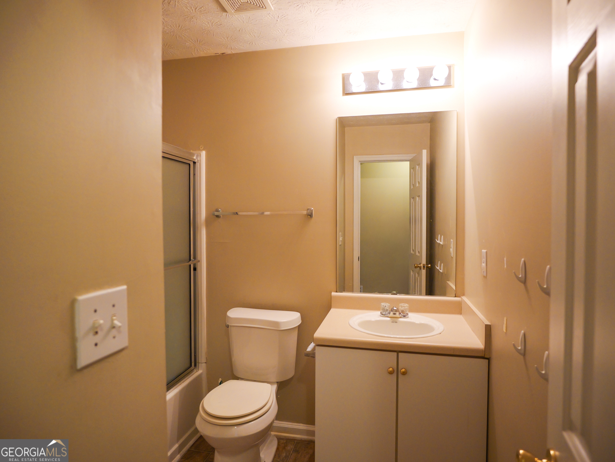 11036 Pebble Ridge Drive Hampton, GA 30228 - Photo 14 of 35 a bathroom with a toilet sink and mirror