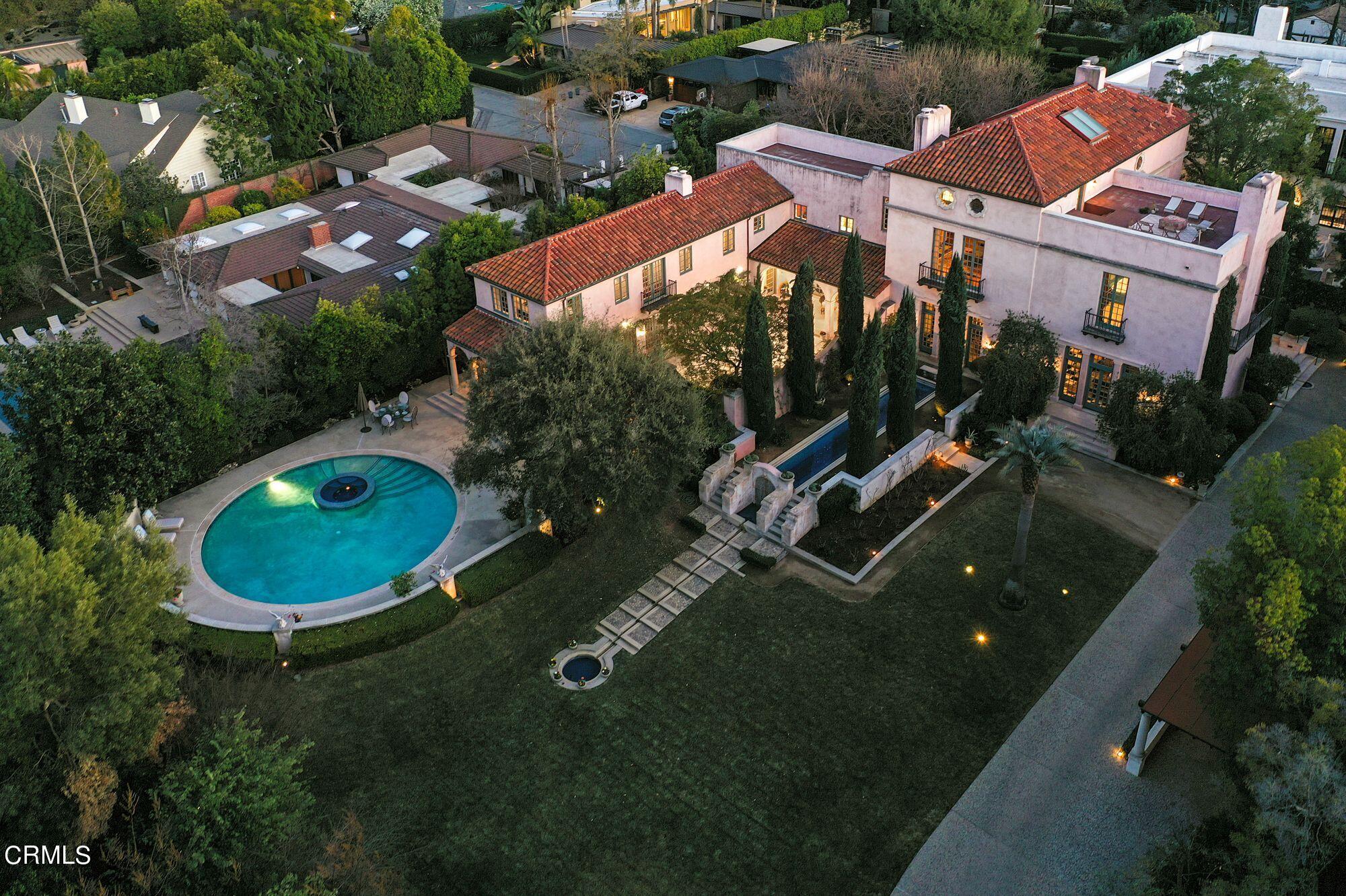 an aerial view of a house with garden space lake and outdoor seating