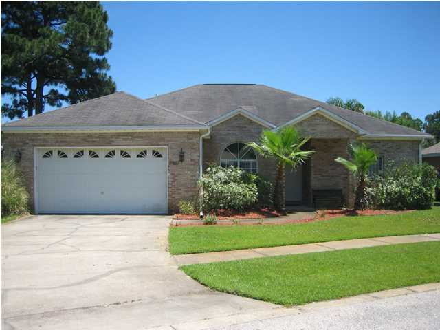3851 Mesa Road Destin, FL 32541 - Photo 1 of 20 a front view of a house with a yard and garage