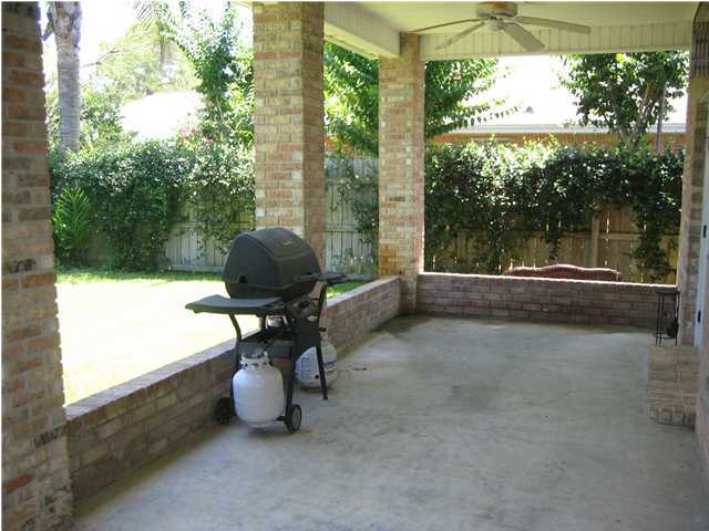 3851 Mesa Road Destin, FL 32541 - Photo 18 of 20 a backyard of a house with table and chairs